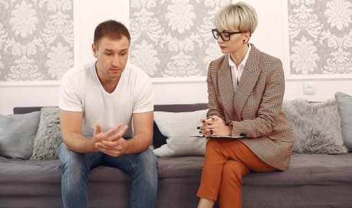 In the psychologist's office. Man and woman talking